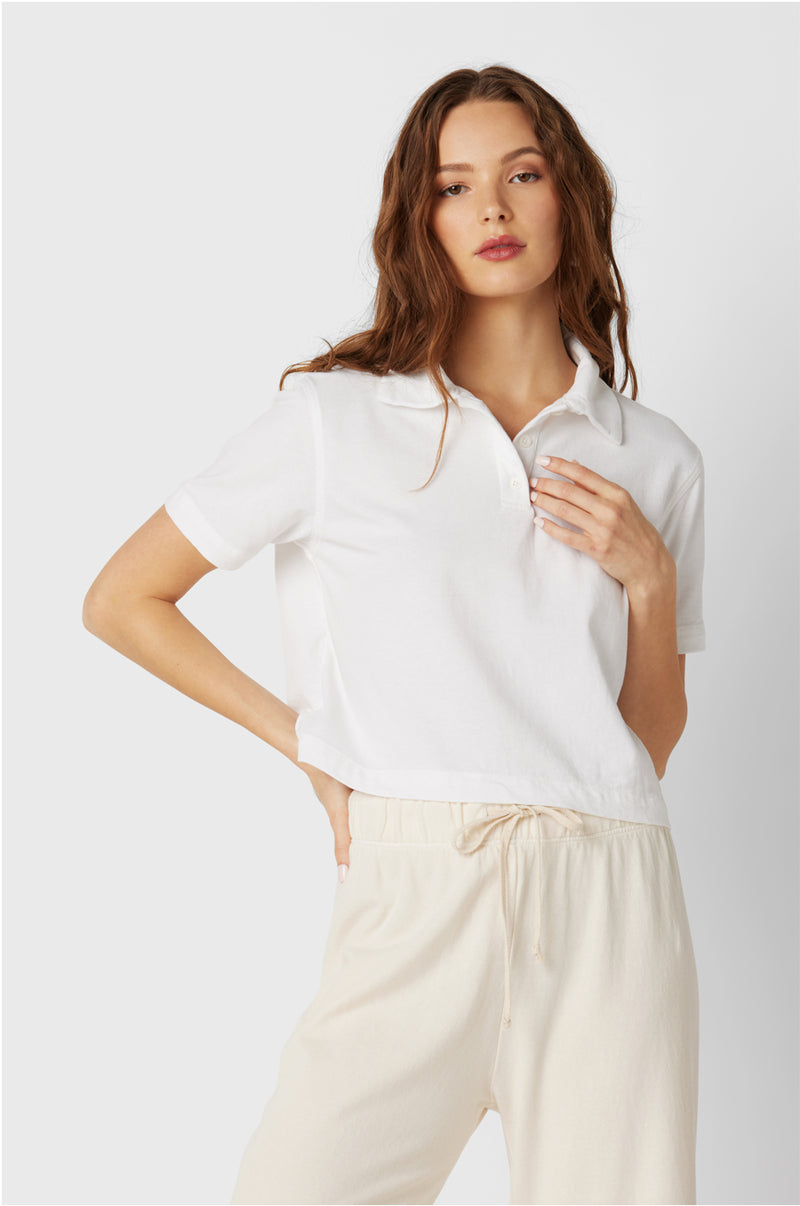 Model wearing the lady & the sailor Polo T-Shirt in White Vintage Cotton.