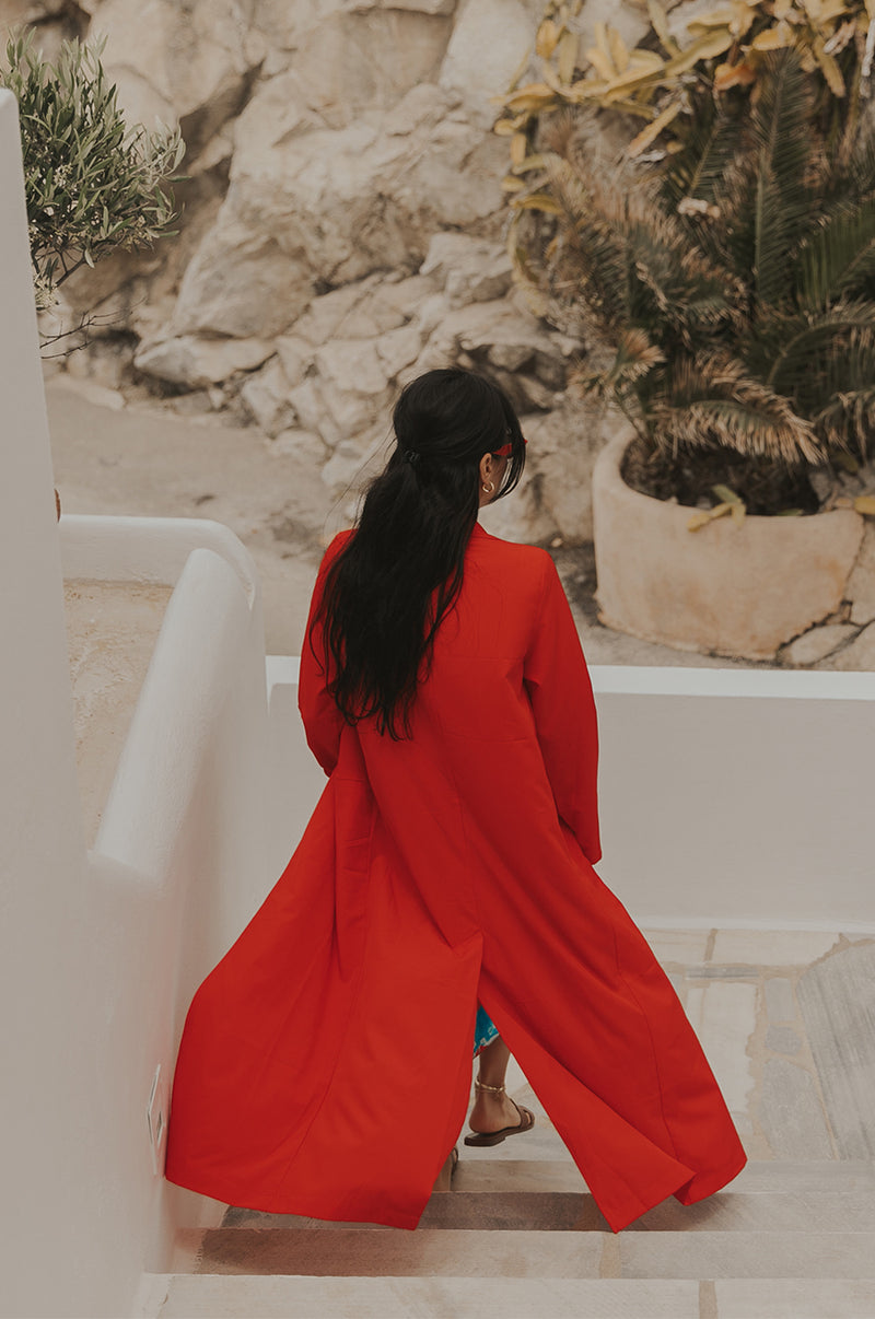 Brunette Model wearing the lady & the sailor The Duster in Geranium.