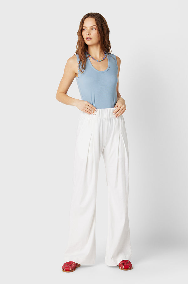 Brunette Model wearing the lady & the sailor the Scoop Neck Tank in Dusty Blue Classic Rib.
