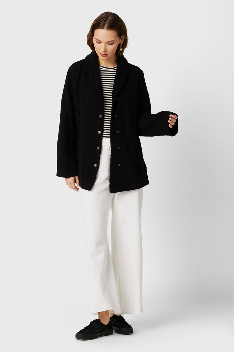 Model wearing the lady & the sailor Snap Cardi in Black Bouclé.