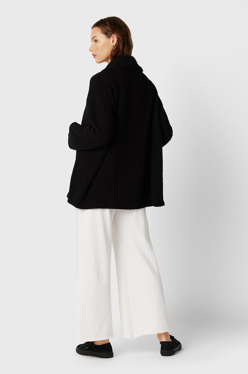 Model wearing the lady & the sailor Snap Cardi in Black Bouclé.