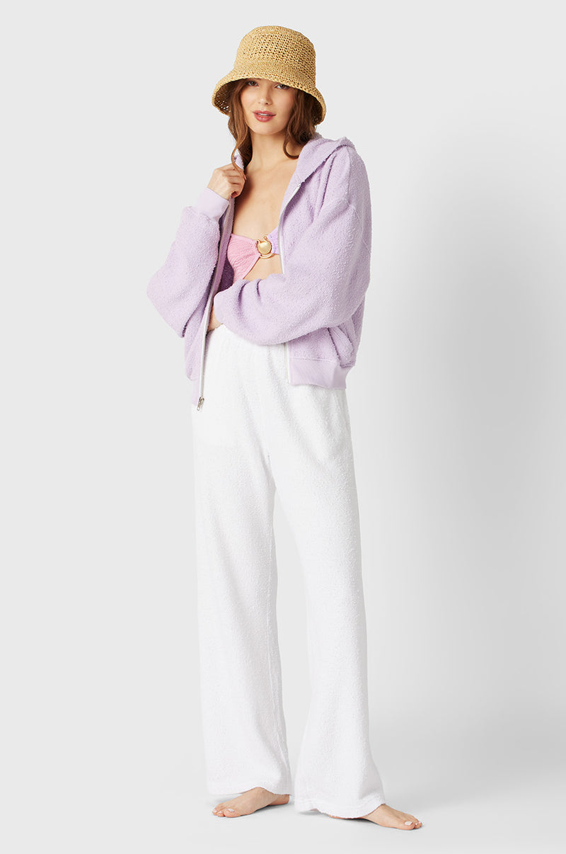 Brunette Model wearing the lady & the sailor the Zip Up Hoodie in Lilac Boucle.