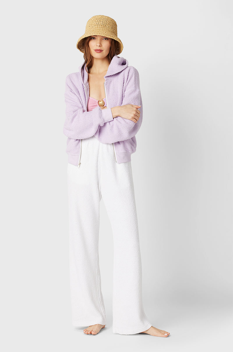 Brunette Model wearing the lady & the sailor the Zip Up Hoodie in Lilac Boucle.