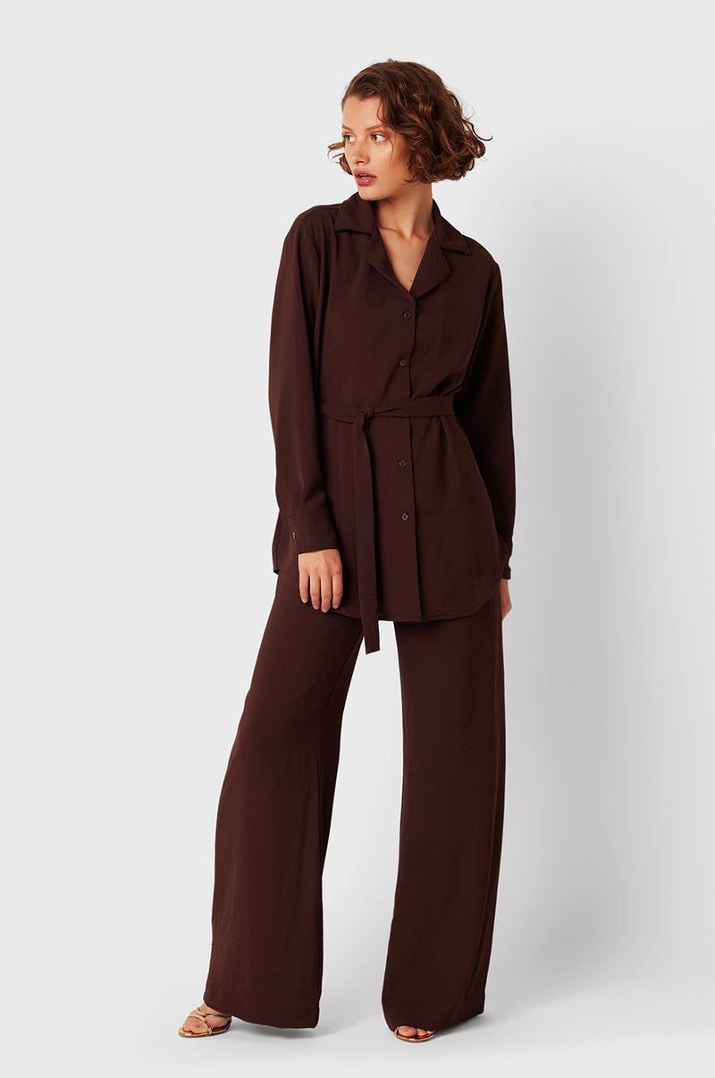Brunette Model wearing the lady & the sailor Belted Button Up in Chocolate Air Flow.