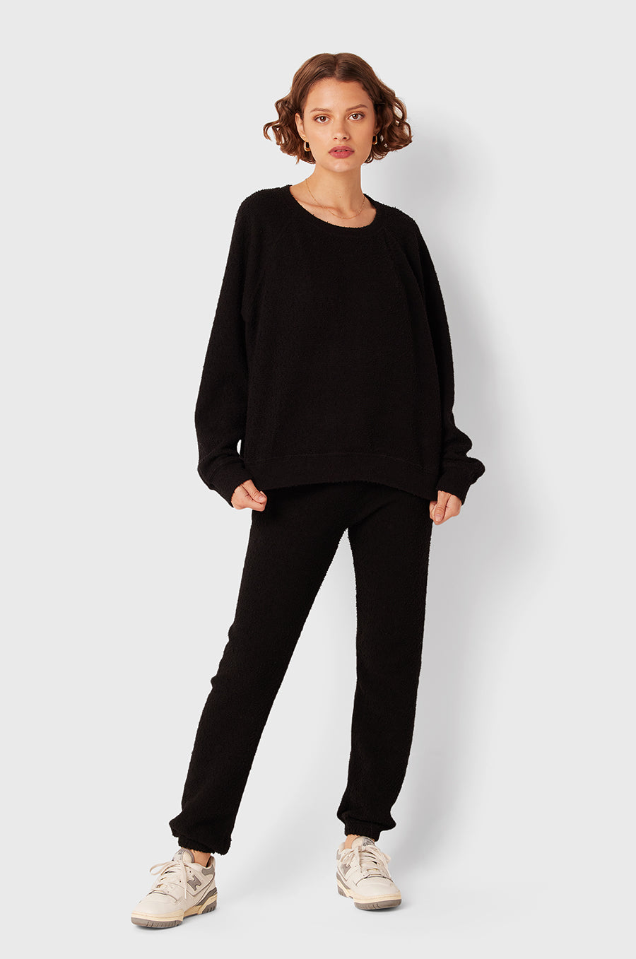Brunette Model wearing the lady & the sailor Full Length Vintage Sweatpant in Black Bouclé.