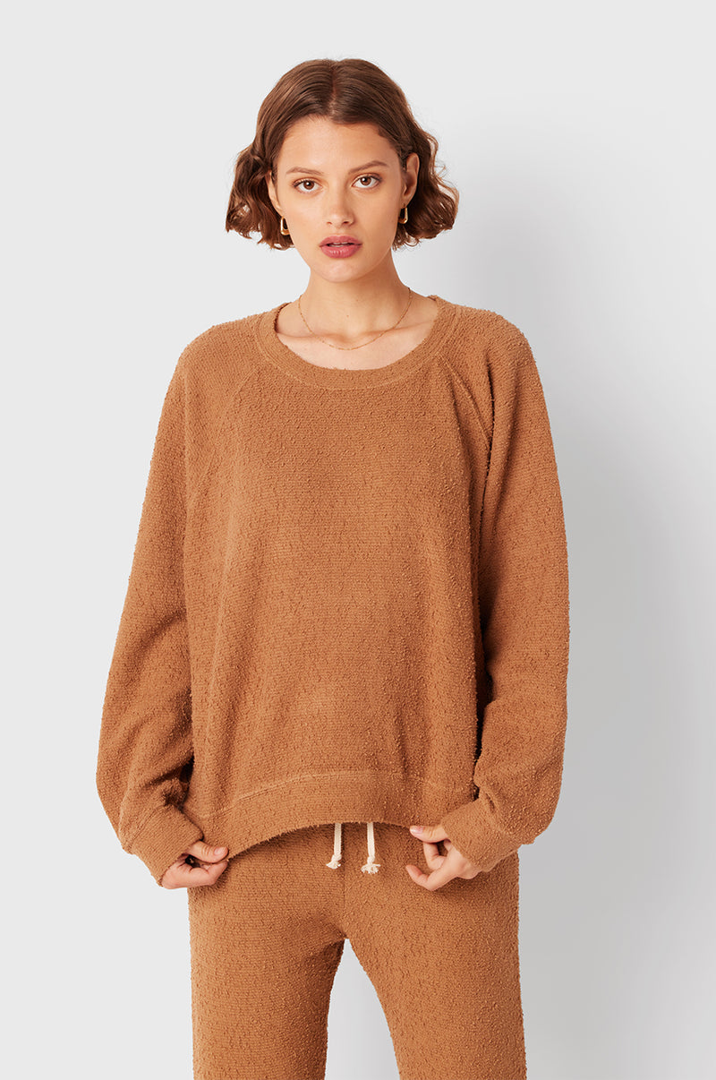 Brunette Model wearing the lady & the sailor Full Length Vintage Sweatpant in Caramel Bouclé.