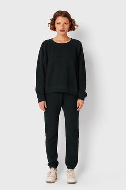 Brunette Model wearing the lady & the sailor Brentwood Sweatshirt in Evergreen Bouclé.