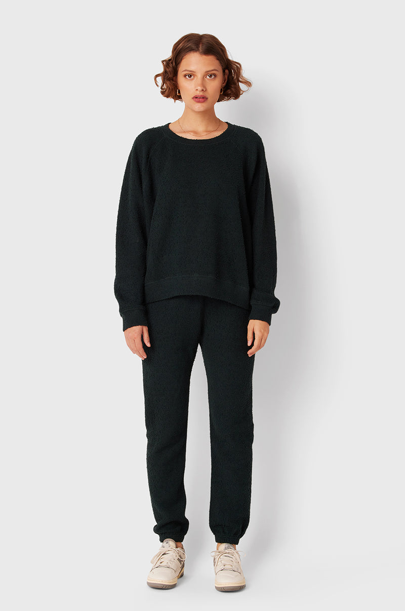 Brunette Model wearing the lady & the sailor Full Length Vintage Sweatpant in Evergreen Bouclé.