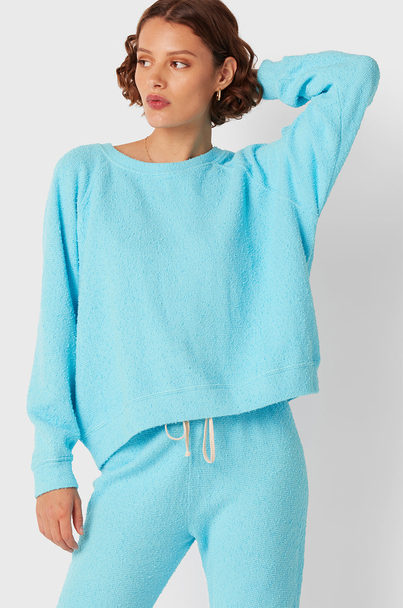 Brunette Model wearing the lady & the sailor Full Length Vintage Sweatpant in Turquoise Bouclé.