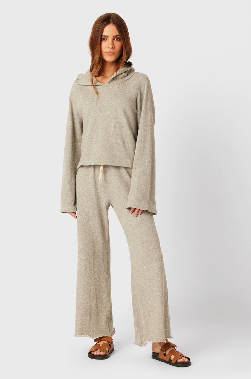 Brunette Model wearing the lady & the sailor French Flare Pant in Heather Grey Organic Cotton.