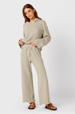 Brunette Model wearing the lady & the sailor French Flare Pant in Heather Grey Organic Cotton.