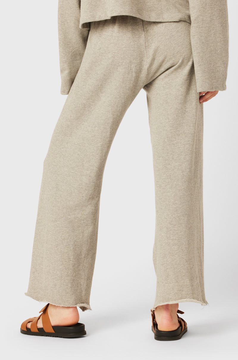 Brunette Model wearing the lady & the sailor French Flare Pant in Heather Grey Organic Cotton.