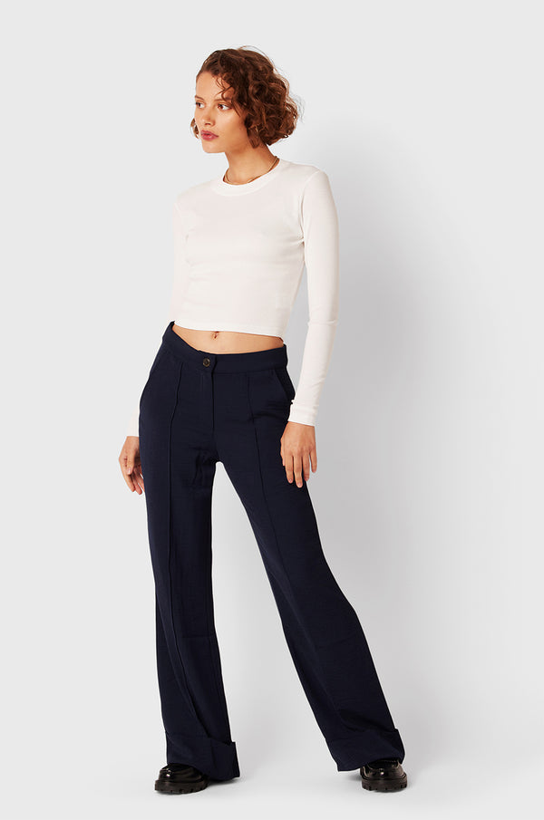 Brunette Model wearing the lady & the sailor Long Sleeve Cropped Tee in White Classic Rib.