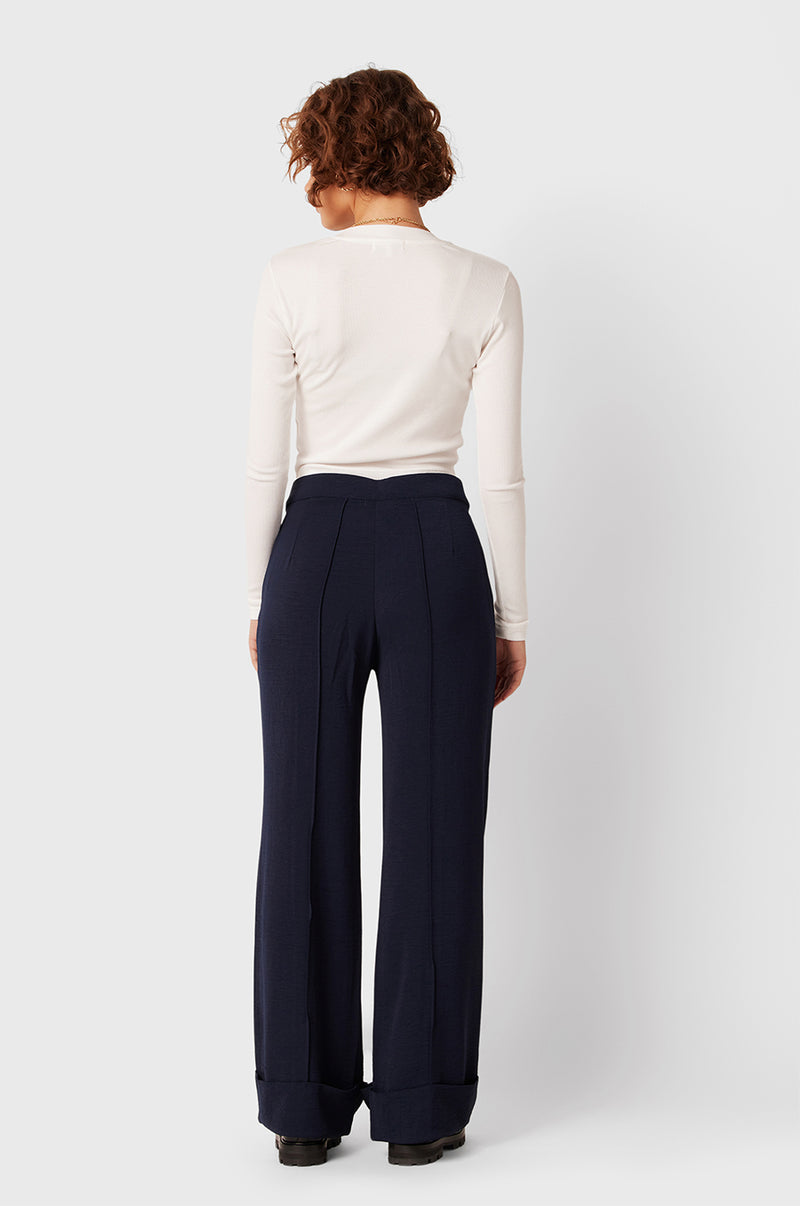 Brunette Model wearing the lady & the sailor Long Sleeve Cropped Tee in White Classic Rib.