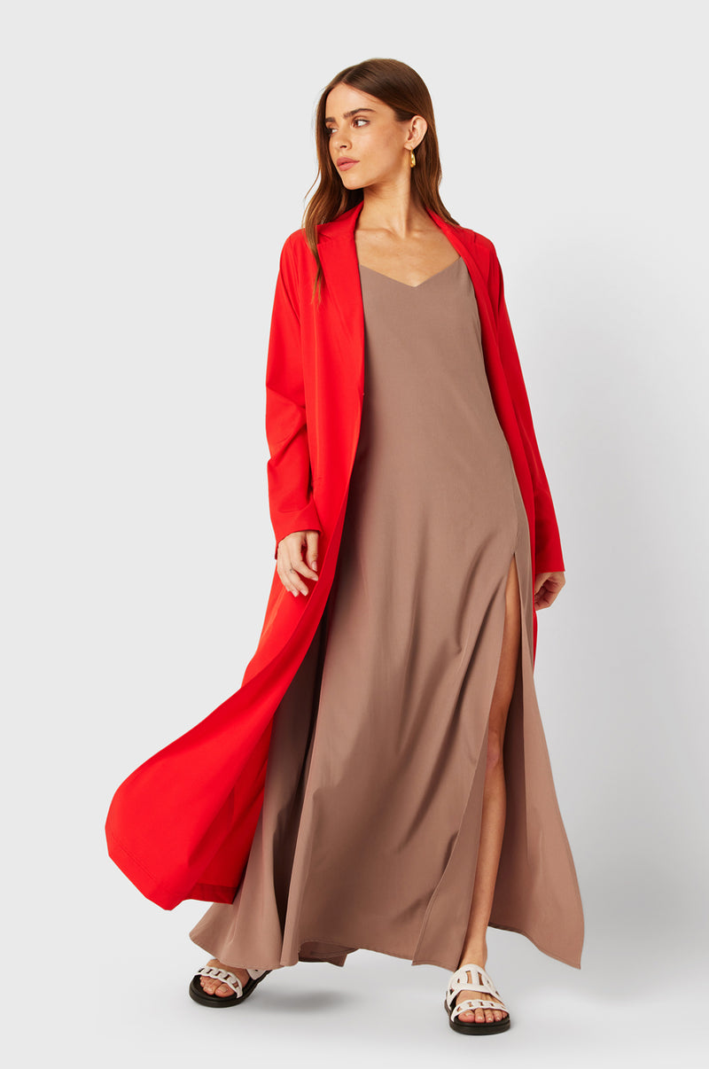 Brunette Model wearing the lady & the sailor The Duster in Geranium.