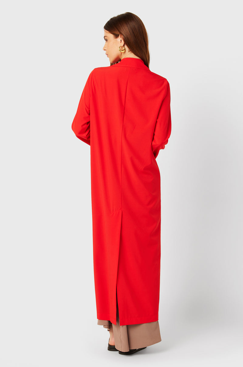 Brunette Model wearing the lady & the sailor The Duster in Geranium.