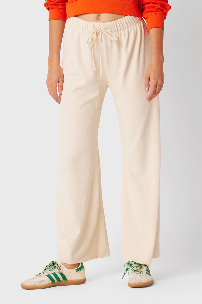 Brunette Model wearing the lady & the sailor French Flare Pant in Ivory Cord.