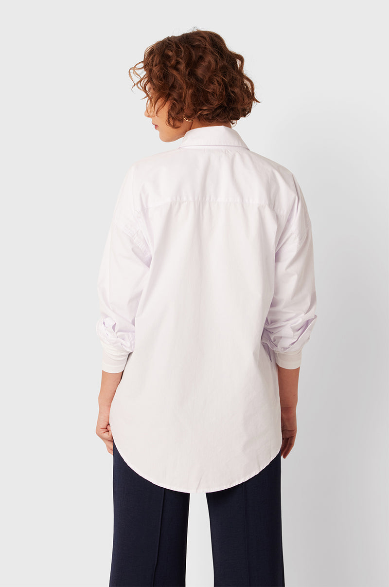 Brunette Model wearing the lady & the sailor Lady Button Up in White Cotton Poplin/Ruby.