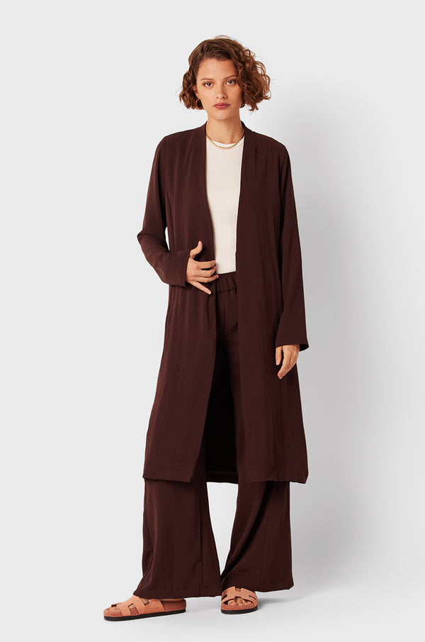 Brunette Model wearing the lady & the sailor Midi Duster Coat in Chocolate Air Flow.
