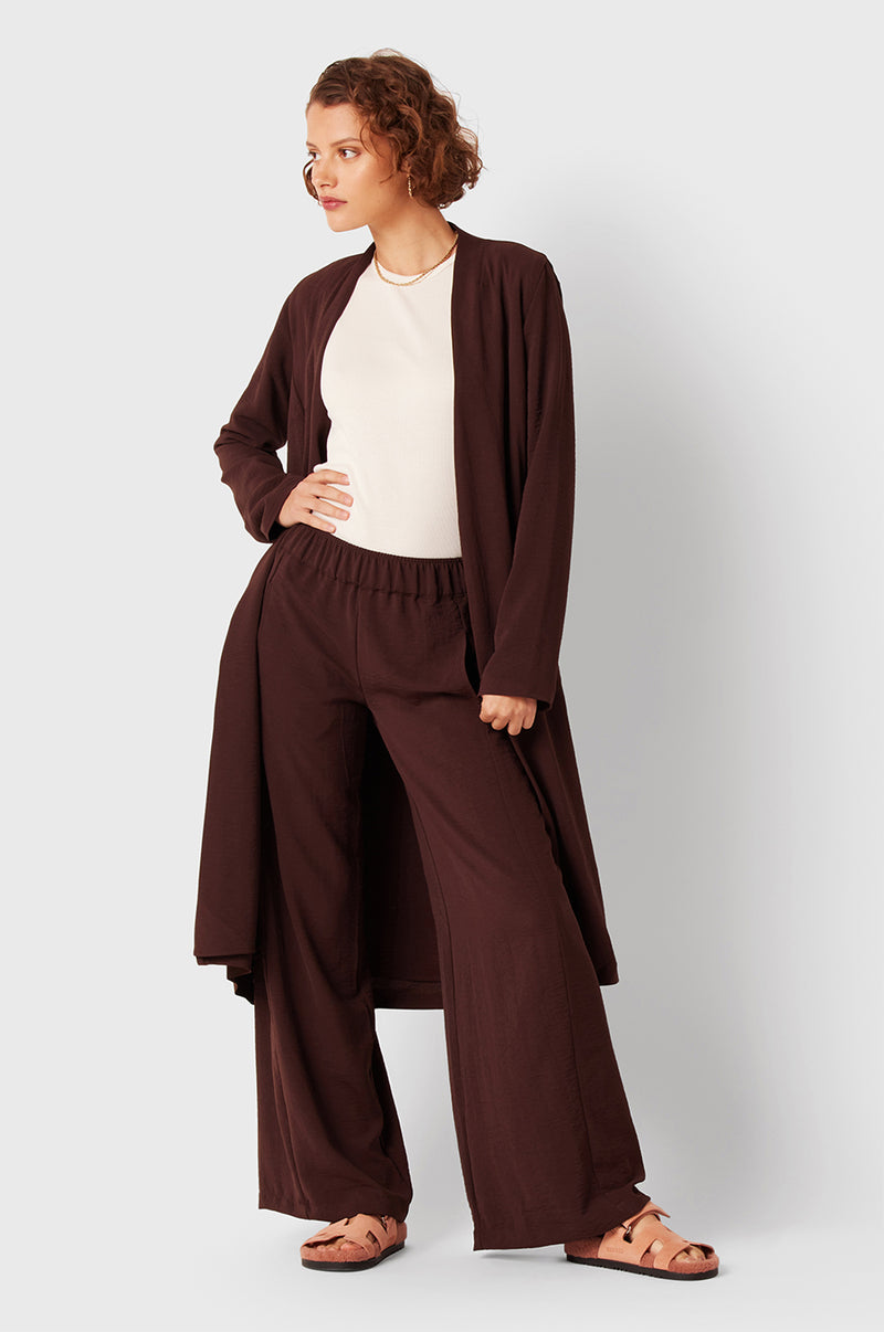Brunette Model wearing the lady & the sailor Palazzo Pant in Chocolate Air Flow.