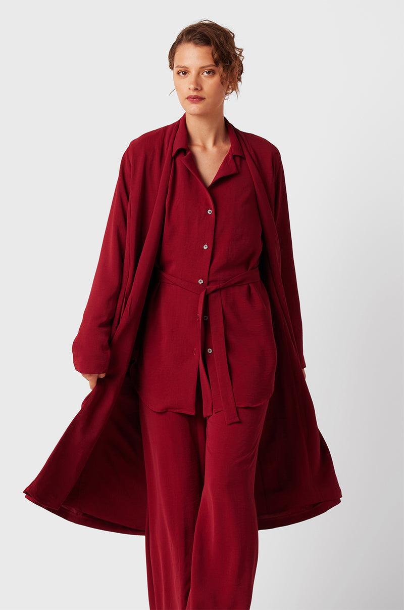 Brunette Model wearing the lady & the sailor Midi Duster Coat in Ruby Air Flow.