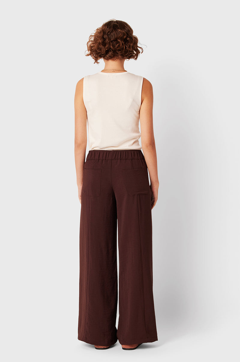 Brunette Model wearing the lady & the sailor Palazzo Pant in Chocolate Air Flow.