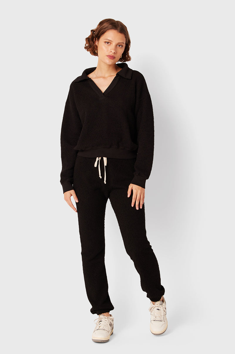 Brunette Model wearing the lady & the sailor Full Length Vintage Sweatpant in Black Bouclé.