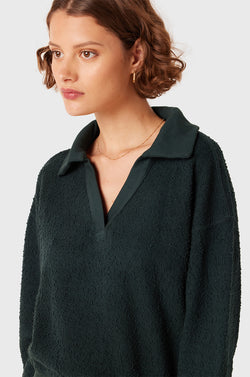 Brunette Model wearing the lady & the sailor Polo Sweatshirt in Evergreen Boulcé.