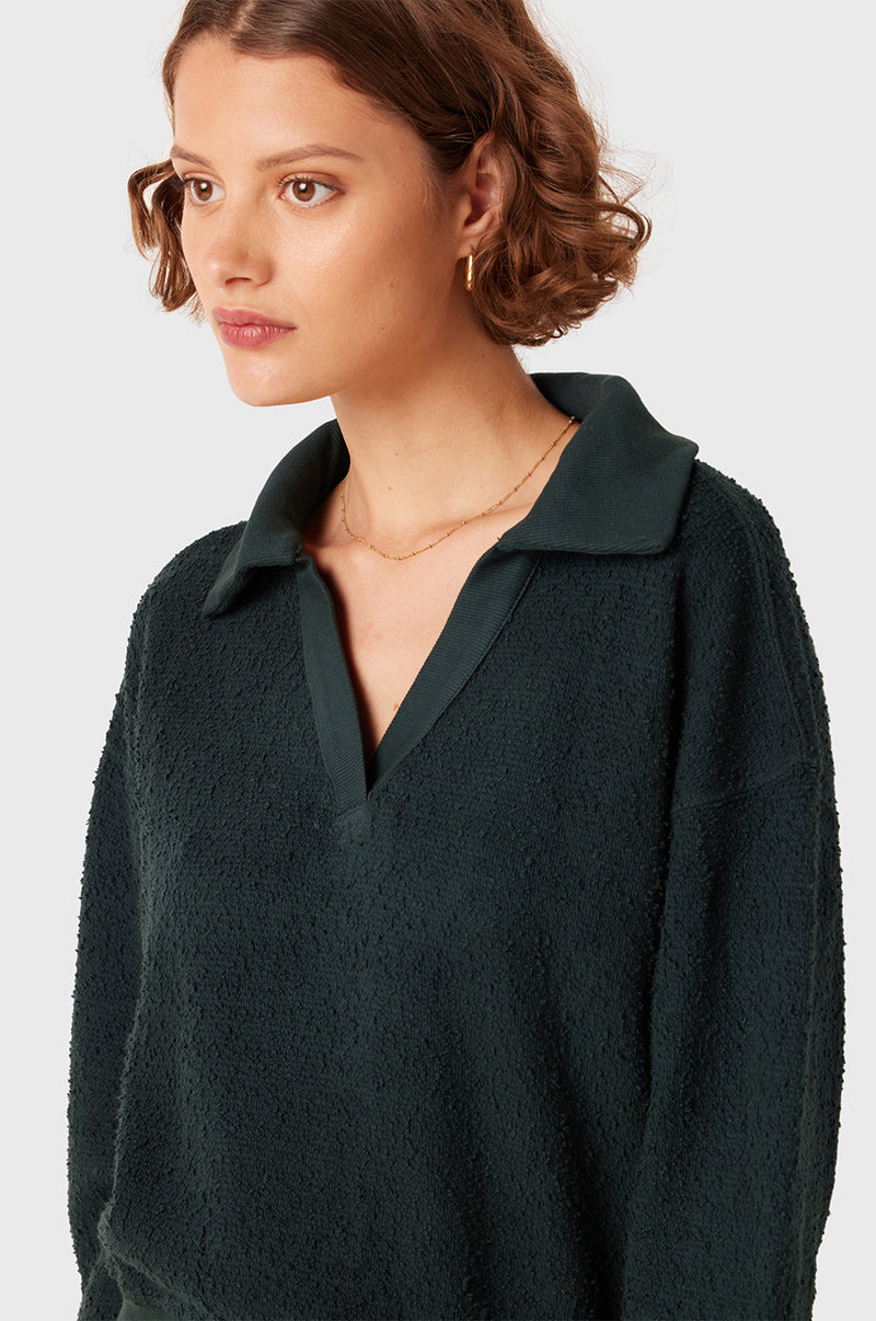 Brunette Model wearing the lady & the sailor Polo Sweatshirt in Evergreen Boulcé.