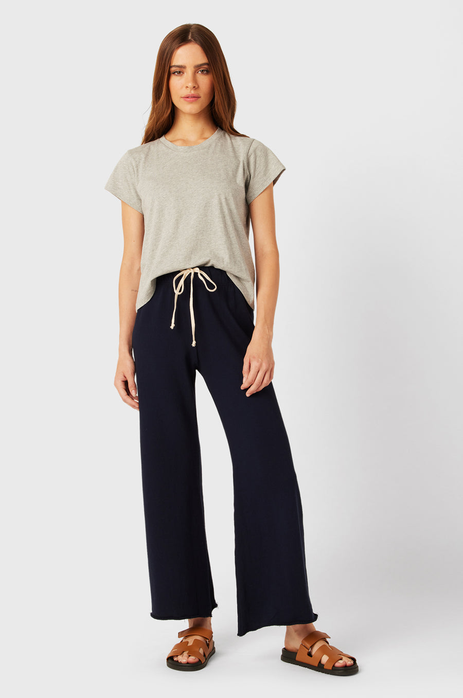 Brunette Model wearing the lady & the sailor French Flare Pant in Navy Organic Cotton.