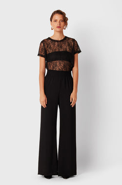 Brunette Model wearing the lady & the sailor Smock Band Pants in Black Air Flow.