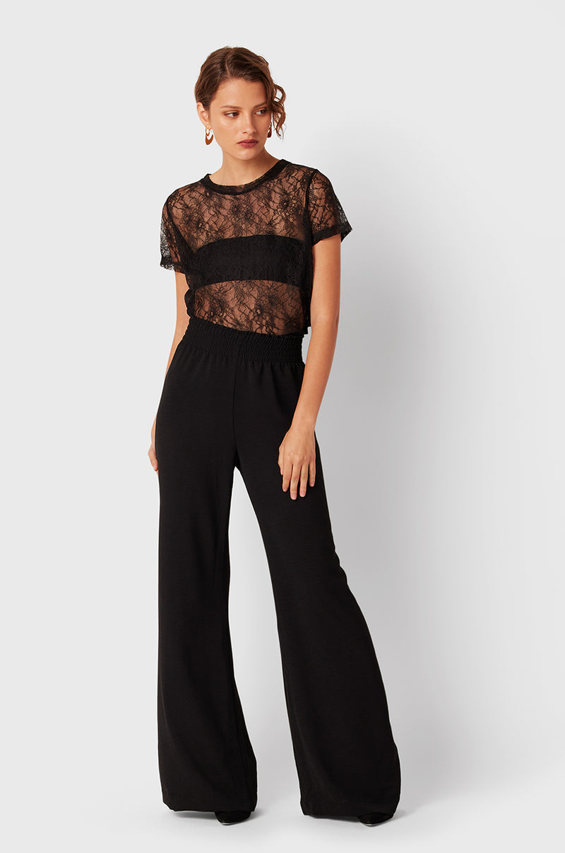Brunette Model wearing the lady & the sailor Smock Band Pants in Black Air Flow.
