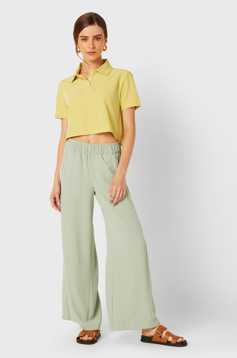 Brunette Model wearing the lady & the sailor SS Polo Blouse in Citrine.