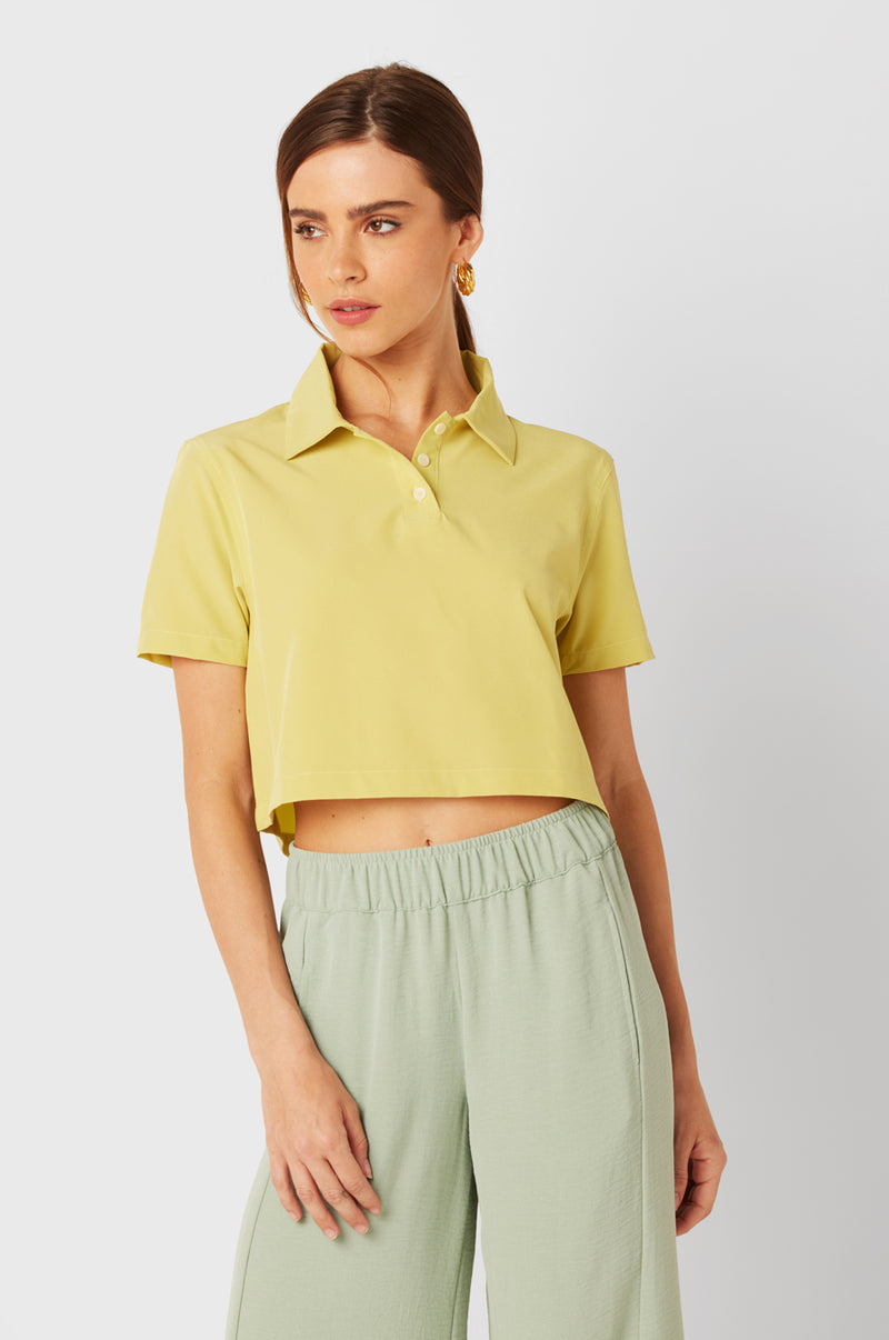 Brunette Model wearing the lady & the sailor SS Polo Blouse in Citrine.