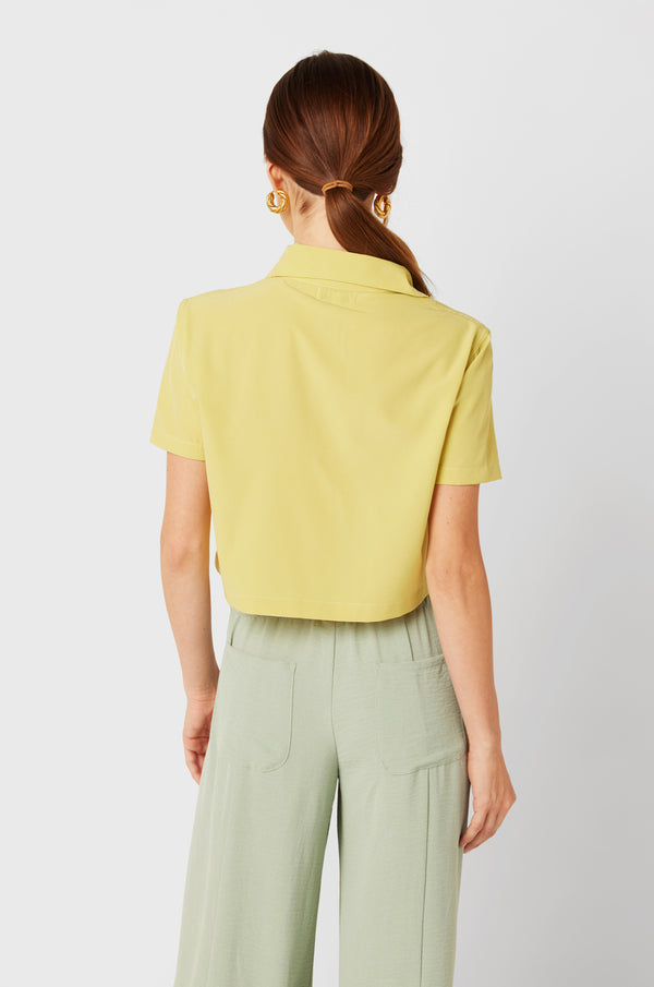 Brunette Model wearing the lady & the sailor SS Polo Blouse in Citrine.