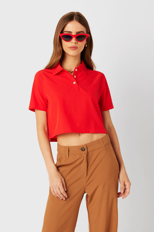 Brunette Model wearing the lady & the sailor SS Polo Blouse in Geranium.