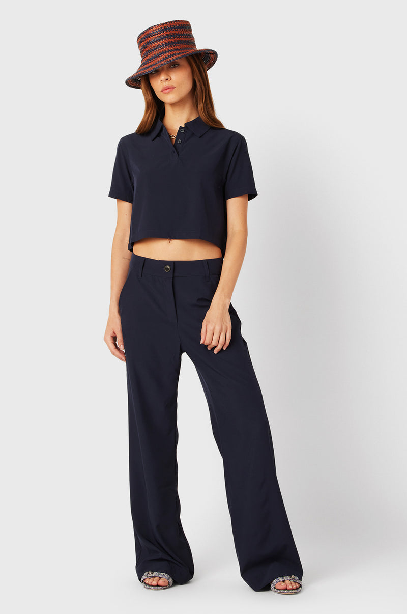 Brunette Model wearing the lady & the sailor SS Polo Blouse in Navy.