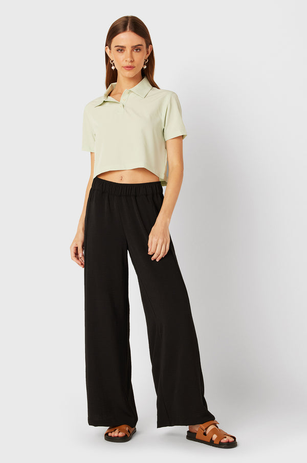 Brunette Model wearing the lady & the sailor Palazzo Pant in Black Air Flow.