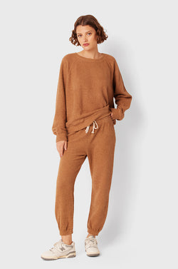 Brunette Model wearing the lady & the sailor Full Length Vintage Sweatpant in Caramel Bouclé.