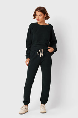 Brunette Model wearing the lady & the sailor Full Length Vintage Sweatpant in Evergreen Bouclé.