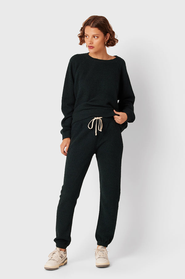 Brunette Model wearing the lady & the sailor Full Length Vintage Sweatpant in Evergreen Bouclé.