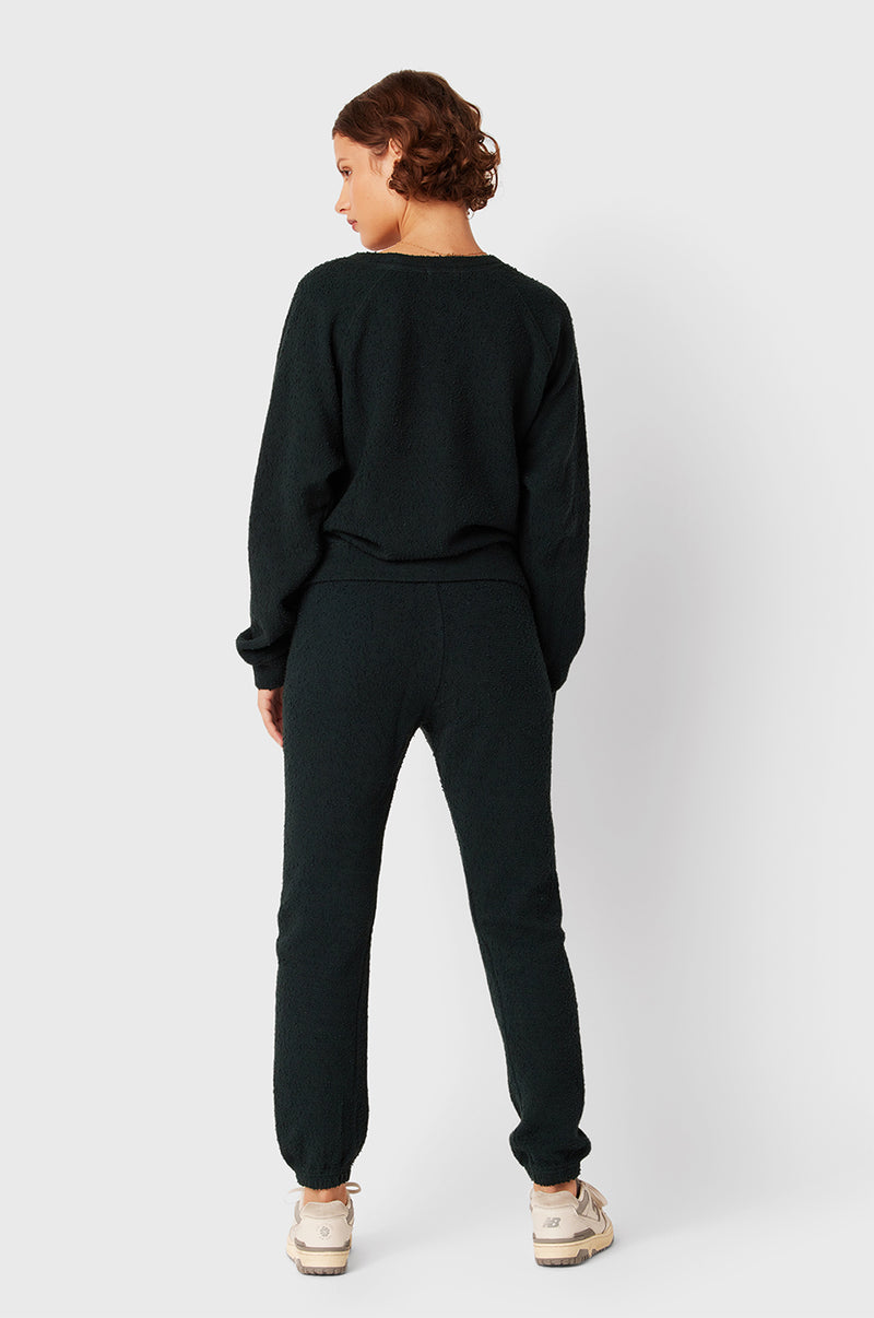 Brunette Model wearing the lady & the sailor Full Length Vintage Sweatpant in Evergreen Bouclé.