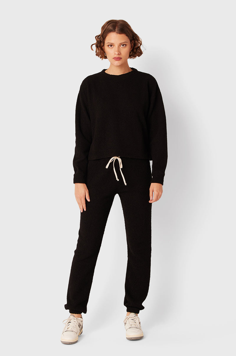 Brunette Model wearing the lady & the sailor Vintage Sweatshirt in Black Boucle.