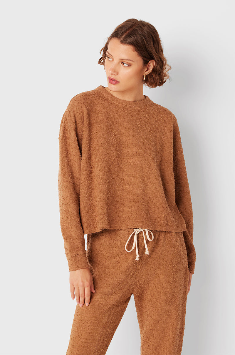 Brunette Model wearing the lady & the sailor Full Length Vintage Sweatpant in Caramel Bouclé.