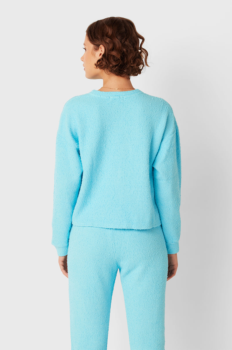 Brunette Model wearing the lady & the sailor Full Length Vintage Sweatpant in Turquoise Bouclé.