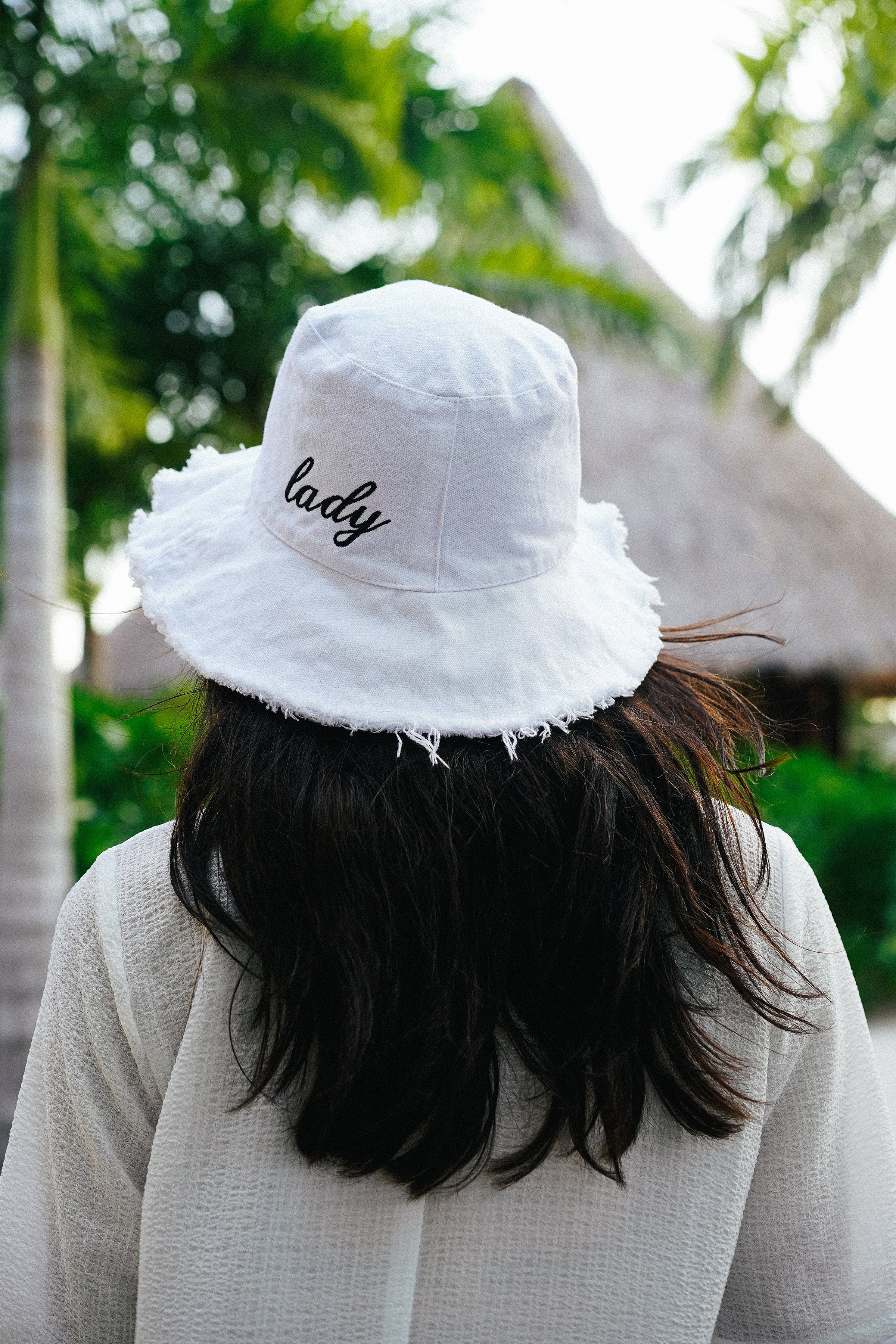 Model wearing the lady and the sailor Lady Bucket Hat in white and black.